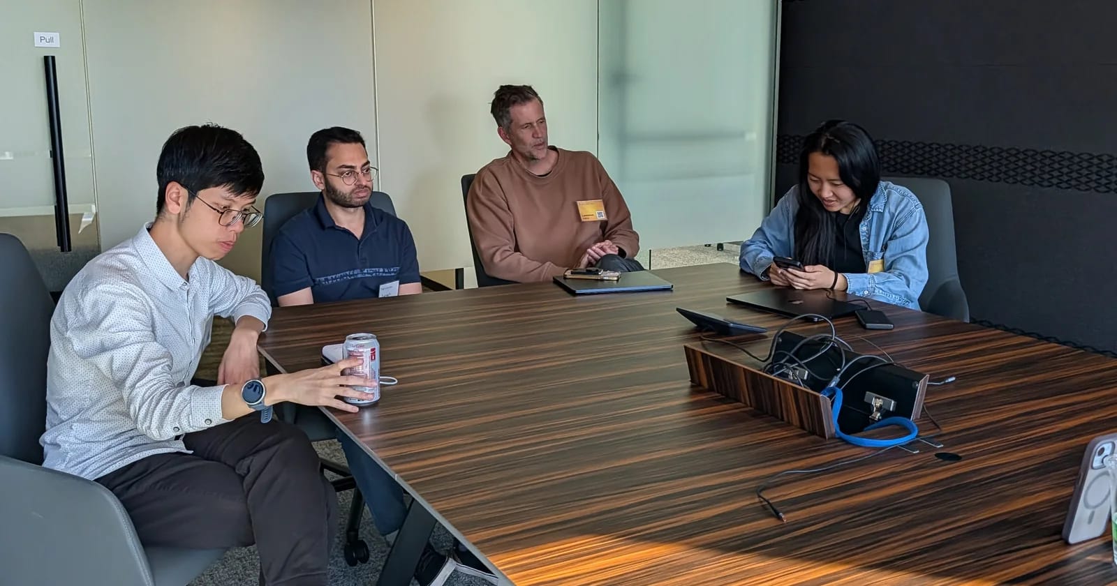 Four FounderNexus participants seated together around a conference table