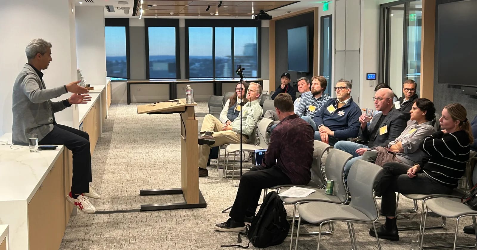 A speaker talking with FounderNexus participants during an in-person session